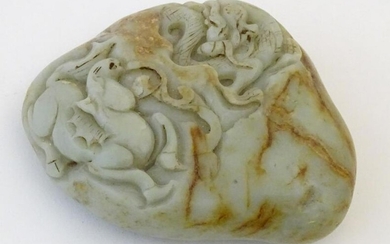 A Chinese jade scroll weight with carved decoration