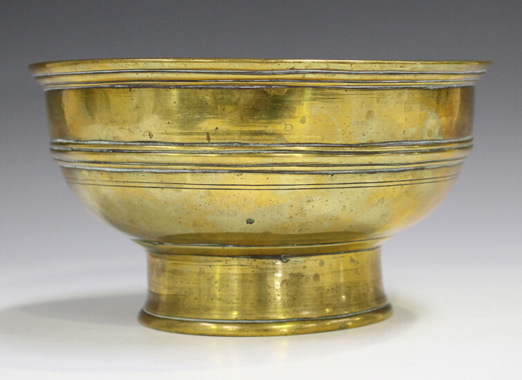 A Chinese polished bronze circular footed bowl, Qing dynasty, the body with horizontal ribbed girdle