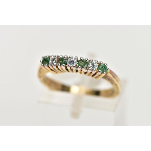 A GOLD-PLATED EMERALD AND CUBIC ZIRCONIA HALF ETERNITY RING,...