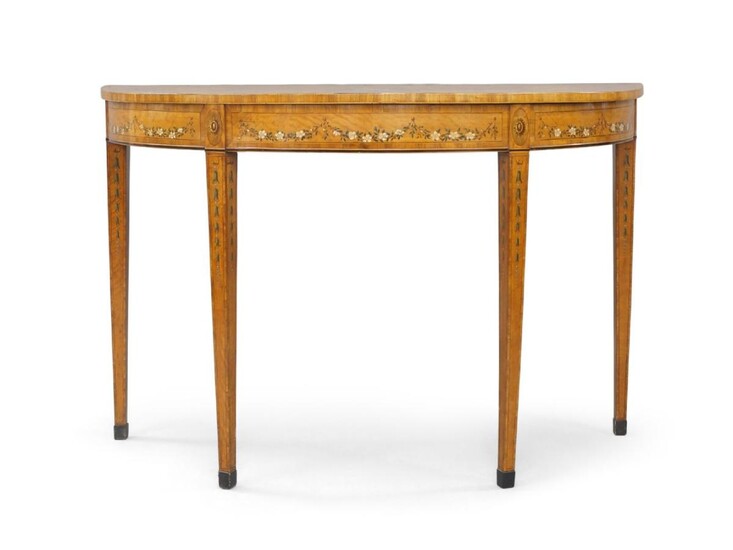 A George III demi lume satinwood console table, mahogany crossbanded, the top hand painted with vase of flowers and bow ribbons, hand painted frieze and legs, raised on square tapered supports to brass caps, 85cm high, 130cm wide, 55cm deep