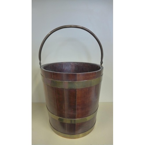 A Georgian style brass bound bucket, 57cm tall, 35cm diamete...
