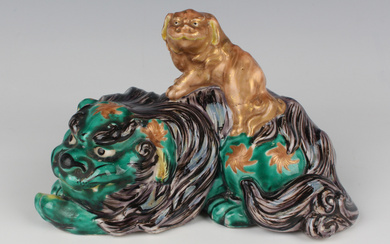 A Japanese Kutani porcelain figure group of a Buddhistic lion and cub, Meiji period, the green and a