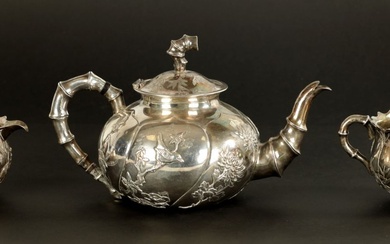 A LATE 19TH CENTURY CHINESE SILVER THREE-PIECE TEA SET...
