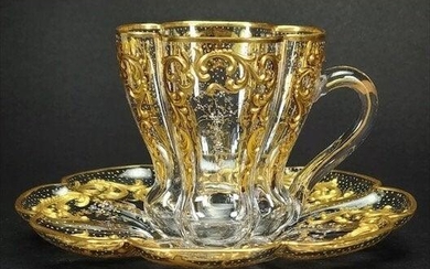 A MAGNIFICENT GILT AND ENAMELED CUP AND SAUCER