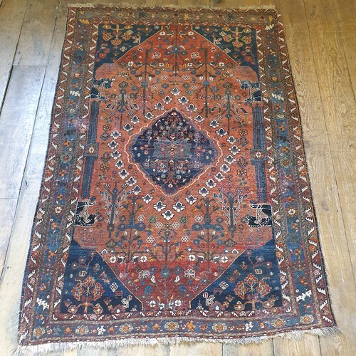A Persian red ground rug, multiple borders, centre decorated...