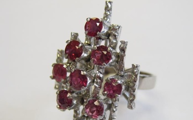 A Ruby Cocktail Ring claw-set nine round stones to...