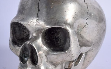 A SILVER PLATED SCULPTURE OF A SKULL. 10.5 cm x 12 cm.