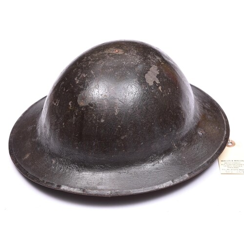 A WWI Brodie’s pattern steel helmet, dark green painted fin...
