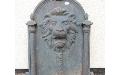 A cast iron fountain head the arched plate with lions mask d...