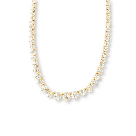 A diamond and fourteen karat gold revière necklace