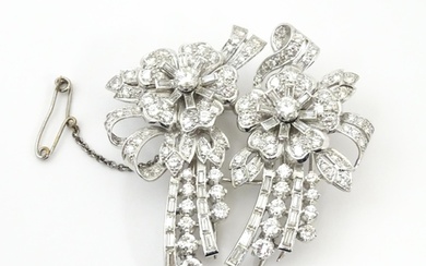 A diamond double clip brooch, the clips with flower and bow ...