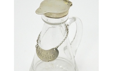 A glass whisky water noggin / jug with silver lid, hallmarke...