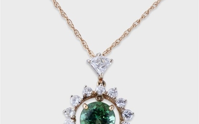 A green tourmaline and diamond pendant designed as a...