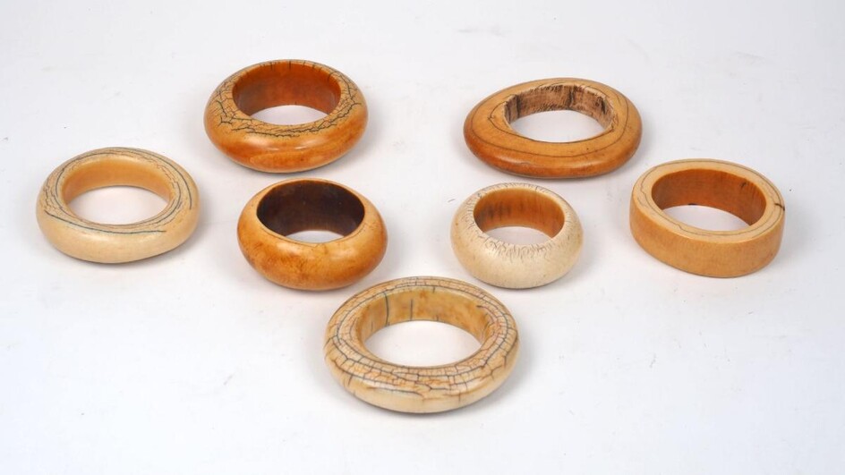 A group of mixed ivory armlets, 19th century, possibly Gungulu, of varying patinas an sizes, of flattened square form form, ranging from 16.5cm long to 25cm long (4)