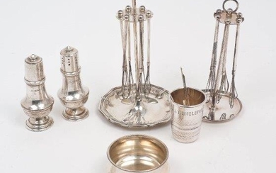 A group of silver and white metal comprising: a silver liqueur cup designed as a thimble and inscribed 'Just a thimbleful', Birmingham, 1977, P H Vogel & Co., 5.2cm high; two sets of miniature whisks on stands (one plated, one stand stamped 835)...