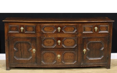 A late 17th century oak low dresser, oversailing top above a...