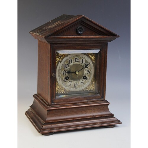 A late 19th century German oak cased eight day mantel clock,...
