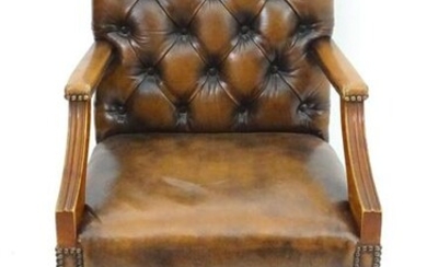 A late 20thC desk chair with deep buttoned leather