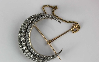 A late Victorian gold backed and silver set diamond crescent brooch