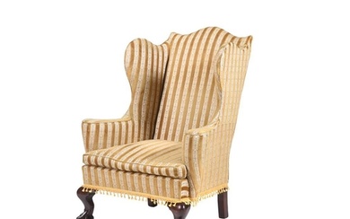 A mahogany and upholstered wingback armchair in George III s...