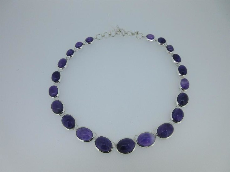 A modern silver necklace set with amethysts
