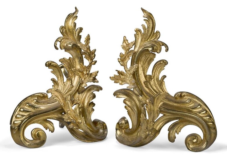A pair of French gilt-bronze chenets, first half 20th century, each of scrolling foliate design mounted with oak leaves, 42cm high, 31cm wide (2)