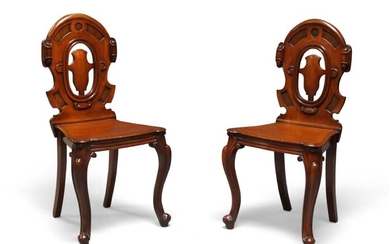 A pair of Victorian mahogany hall chairs, c.1860, cartouche shaped carved and pierced backs, solid seats, raised on cabriole legs to front, 91cm high (2)