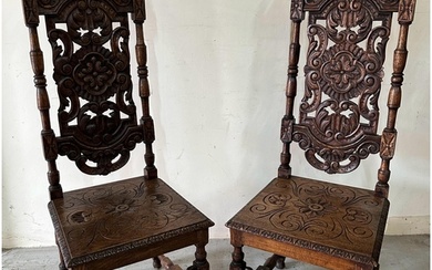 A pair of Victorian style oak hall chairs with carved seats ...