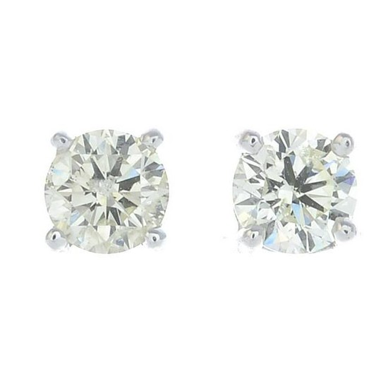 A pair of brilliant-cut diamond earrings.Estimated
