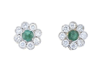 A pair of emerald and brilliant-cut diamond floral...