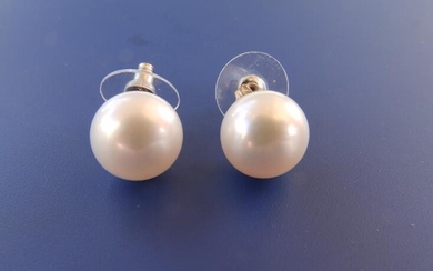 A pair of large cultured pearl earrings, each pearl...
