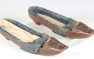 A pair of late 18th/early 19th century French walnut lady's shoes, the fronts finely carved wit