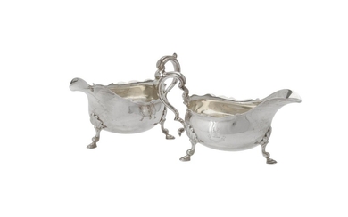 A pair of late Victorian silver shaped oval sauce boats by Thomas Bradbury & Sons