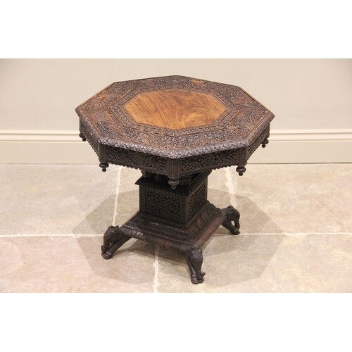 A profusely carved Anglo-Indian teak pedestal occasional tab...