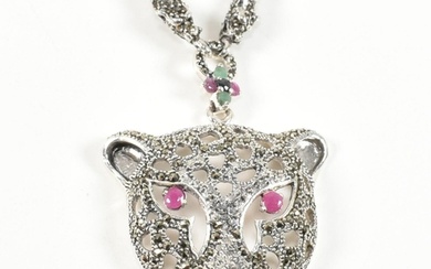 A silver gem set leopards head pendant necklace. The pendant...