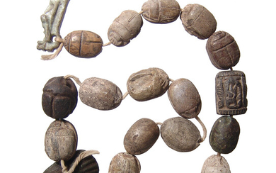 A strand of 16 Egyptian scarabs and a pair of amulets