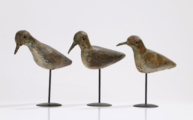 A trio of early 20th Century Shorebird decoys, the painted body with red bead eyes raised on later