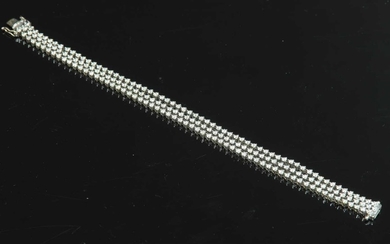 A white gold three row diamond set line bracelet