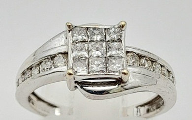 An 18K White Gold and Princess Cut Diamond Ring. Nine small ...