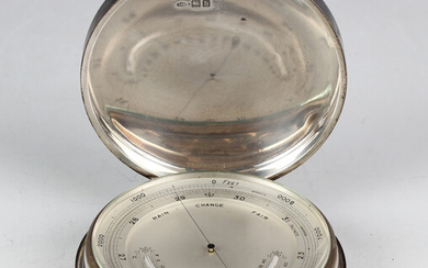 An Edwardian silver cased desk barometer, the silvered dial with mercury thermometer, the cylindrica