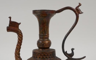 An Islamic gilt bronze ewer with a ribbed body,...