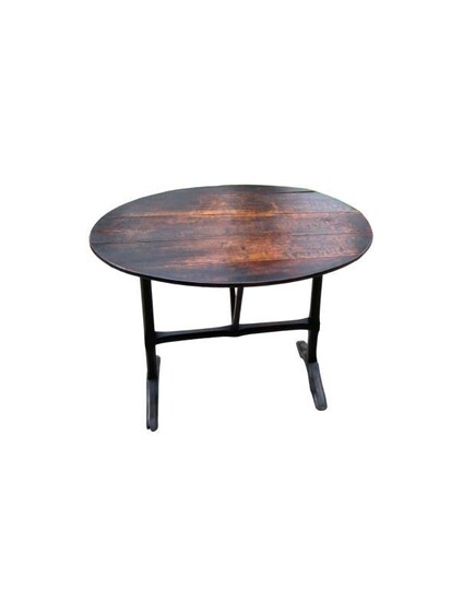 An antique oak oval occasional tilt-top table on folding...