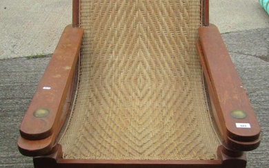An early 20th century teak plantation chair, with curved wov...