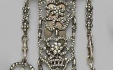 An openworked silver chain entirely set with facetted...
