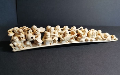 CUT TOOTH - Ivory - Signed Kazuo 一雄 - A procession of rakan 羅漢 (arhats), deities, karako and oni - Japan - 19th century