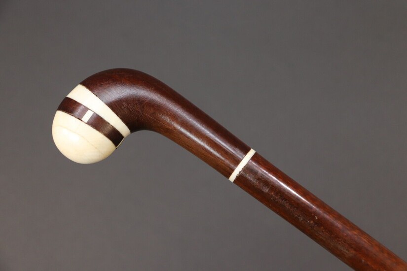 Cane with exotic wood shaft, spherical curved knob with ivory tip. Early 20th century. Height 91 cm