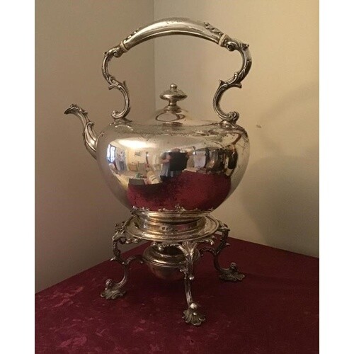 Large solid silver kettle standing on a 4 legged stand with ...
