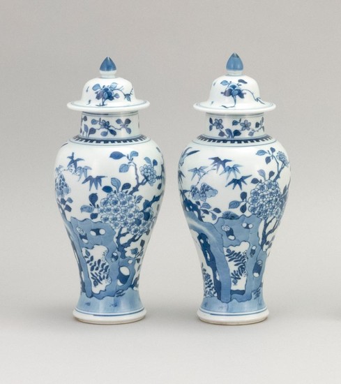 PAIR OF CHINESE BLUE AND WHITE PORCELAIN COVERED JARS In inverted pear shape, with bird and flower decoration. Heights 9.25".