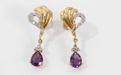 Pair of 18ct gold diamond and amethyst pendant earrings with a pear cut amethyst surmounted by three diamonds suspended from a gold diamond-set scroll. 33mm