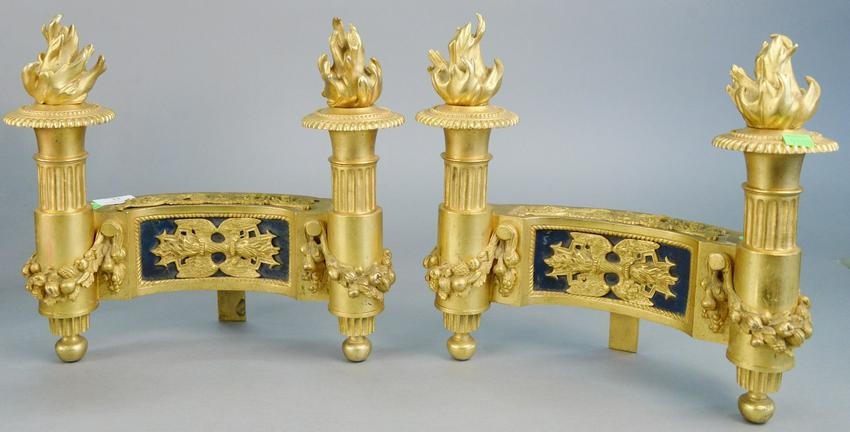 Pair of French bronze dore chenets having flaming torch